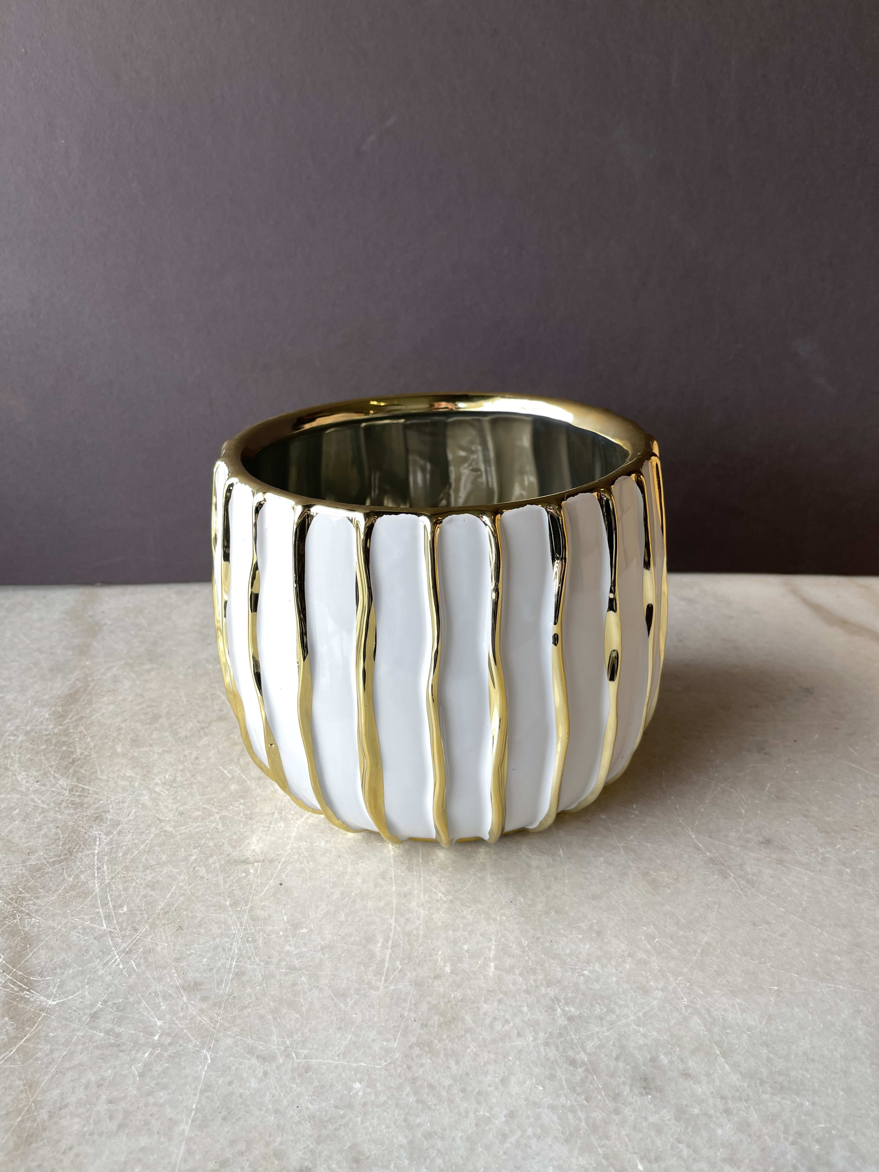 White and gold ceramic planter with vertical ridges