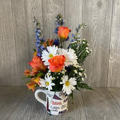 Mixed bouquet in a white mug with orange and white flowers