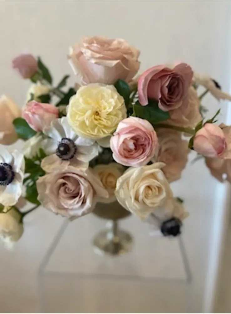 I’m A Boss - A lush cluster of blush, cream, mauve and peach roses arranged with striking white anemones creates a soft, romantic flower arrangement perfect for birthdays, spring celebrations, or a thoughtful thank-you. This flower arrangement gives the person you're thinking of a fresh, garden-fresh feeling-delicate pastels and the anemones' dark centers draw the eye and make the bouquet feel both elegant and effortlessly modern.  Tightly gathered into a rounded, airy composition and presented in a clear glass vase, the mix of roses and anemones offers a pleasing contrast of velvety petals and crisp, graphic blooms. The palette reads feminine and refined without being fussy, making it a lovely choice for a mother, friend, coworker, or anyone who deserves to feel genuinely celebrated.  This arrangement arrives ready-to-display in its glass vase; simply trim stems if needed and refresh the water every few days to extend vase life. It's the kind of bouquet that brightens a kitchen table, office desk, or bedside-an easy, elegant way to say "I'm thinking of you."