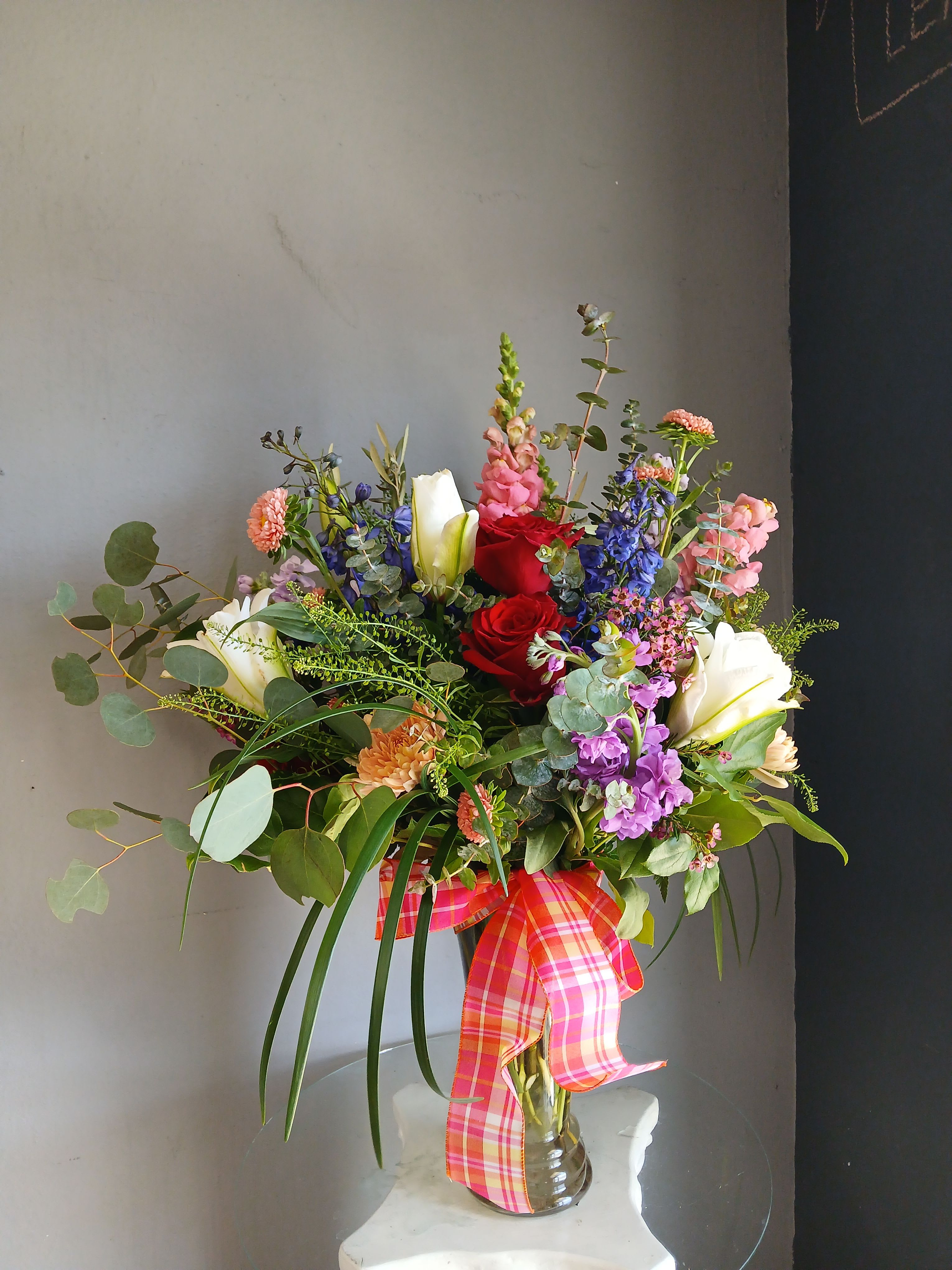 #754 Designer Choice Flower Arrangement  - This beautiful flower arrangement of fresh mixed seasonal blooms is made by local designers in the heart of Orange California. Hand crafted and perfect for every occasion, from birthdays and new babies to sympathy and just because. The best choice to show you are thinking of that special someone. Can be sent as a local delivery or in-store pickup. This is an original, one of a kind arrangement. Order now before it's too late!  UPGRADES: All upgrades are applied at the designer’s discretion and fulfilled to value using the freshest seasonal and/or premium flowers available. Container upgrades may be included when possible; otherwise, value is reflected in the floral selection while maintaining the original design style. 