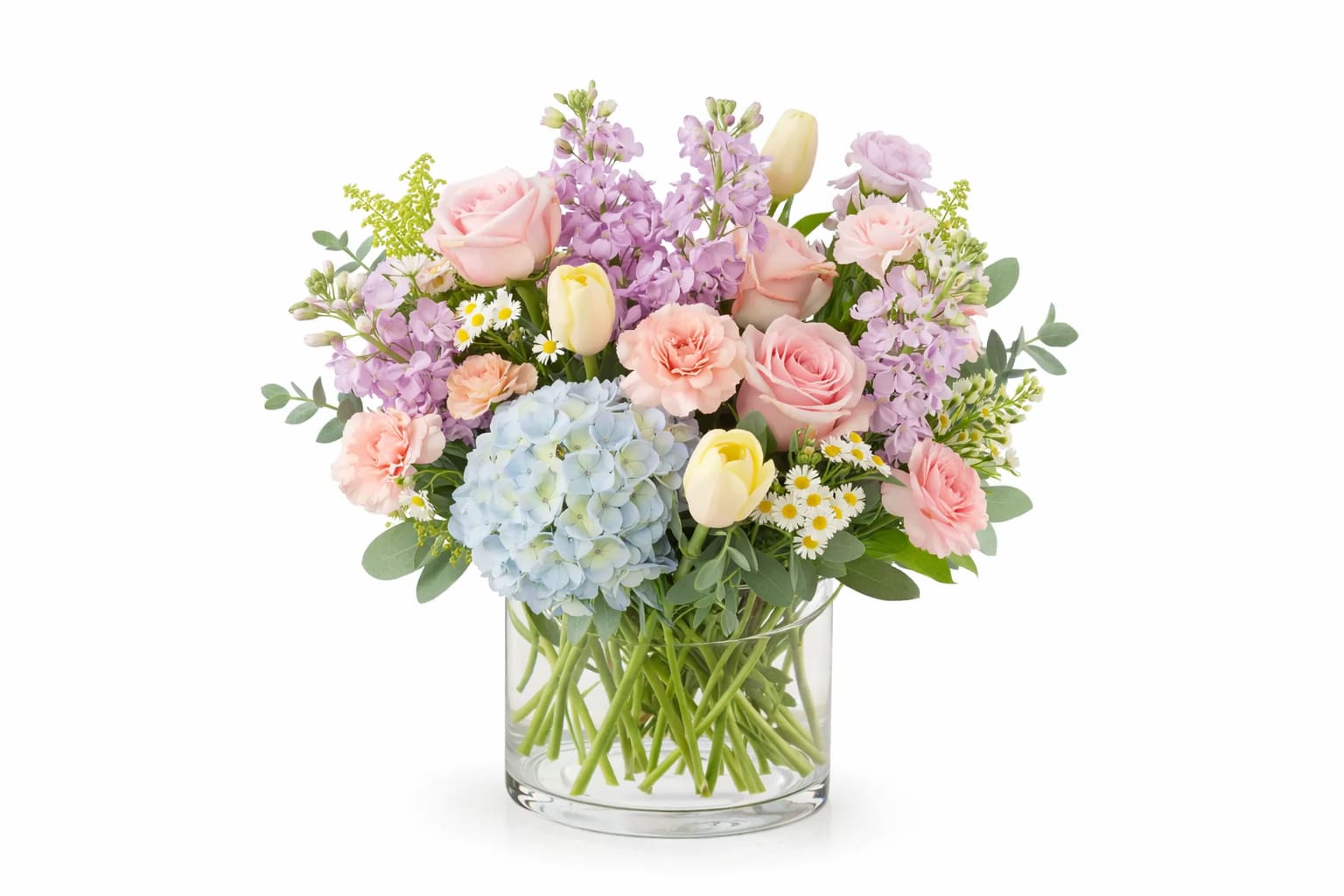 Whimsical Spring - Featuring light blue hydrangea, blush roses, peach carnations, pale yellow tulips, lavender stock, daisies and greenery.