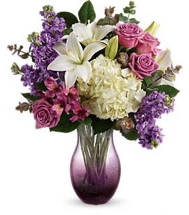 Teleflora's True Treasure Bouquet - White asiatic lilies, white hydrangea, lavender stock, and purple alstroemeria are accented with eucalyptus and leather leaf. Delivered in a purple or clear vase.