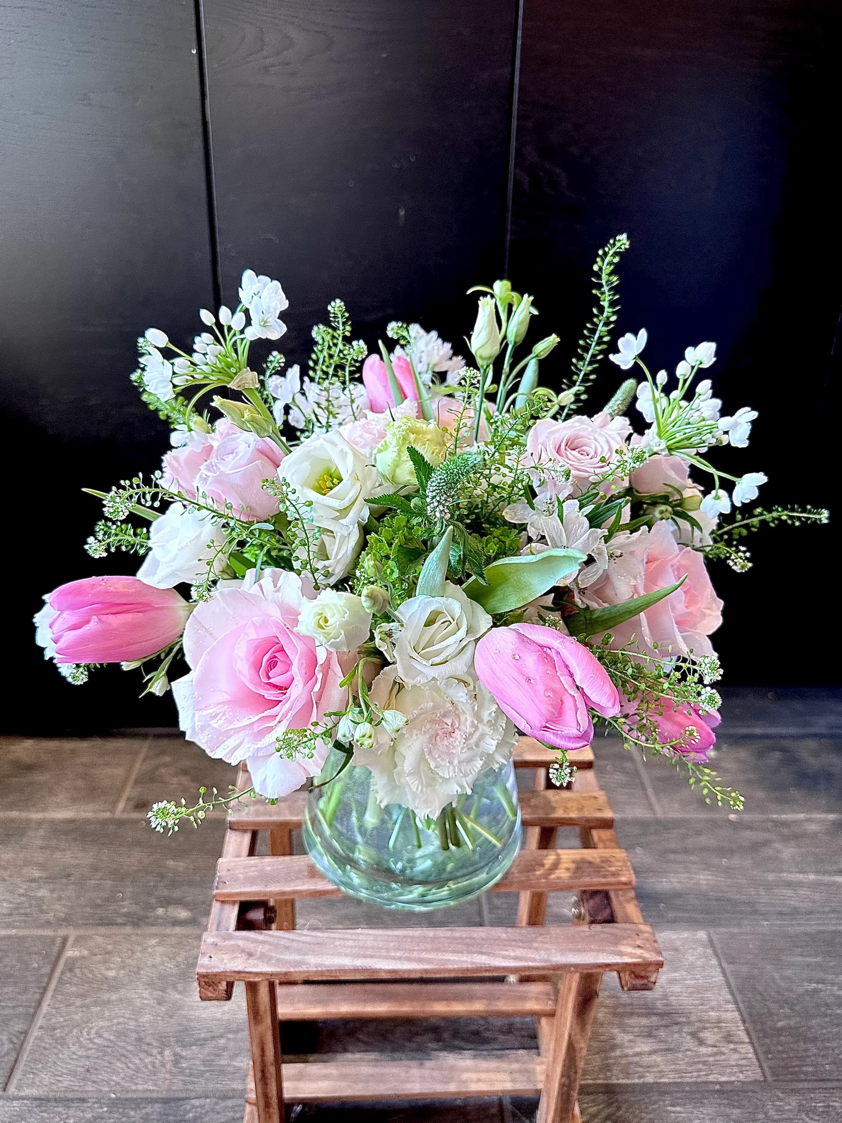 Blooming Love - May my soul bloom in love for all existence--- Rudolf Steiner. This arrangement comprises Pink Roses, Pink Tulips, Lisianthus, White Allium, Veronica, and Seasonal greens