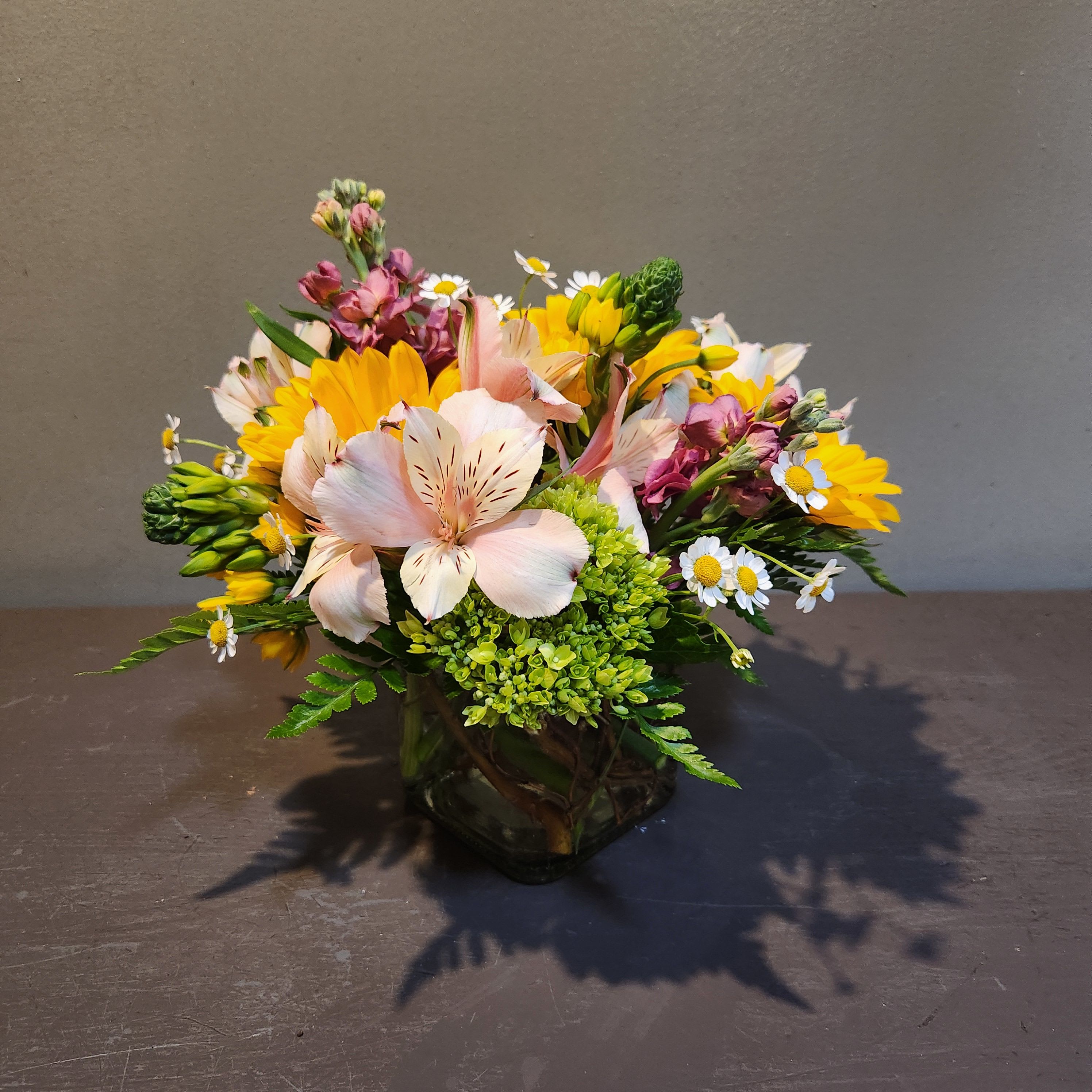 Petite Garden Vase  - A wonderful petite arrangement that can brighten anyone's day!!  Measures approx. 11"Tx11"W and arrives in a glass vase.