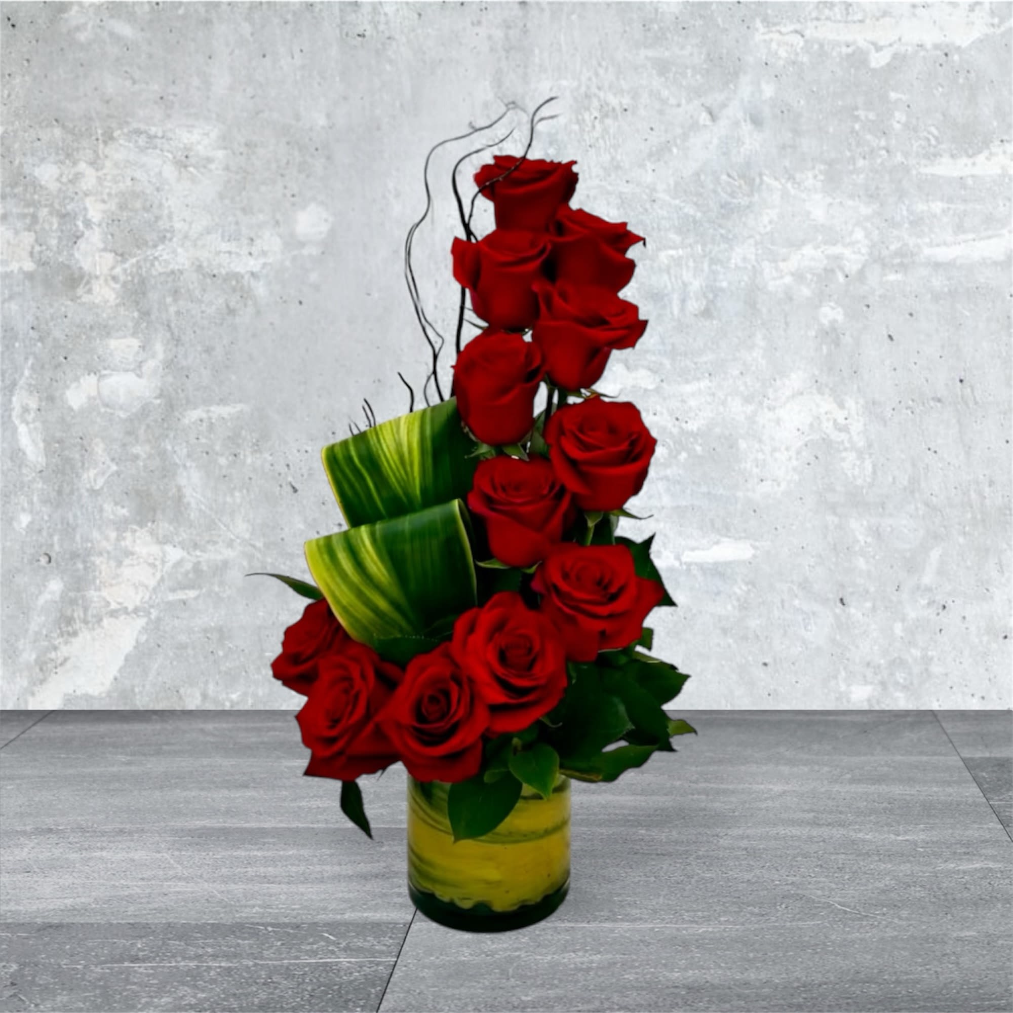 Lovely Roses  - This beautiful arrangement of one dozen Red Roses, lush variegated accent leaves in 5" cylinder vase.