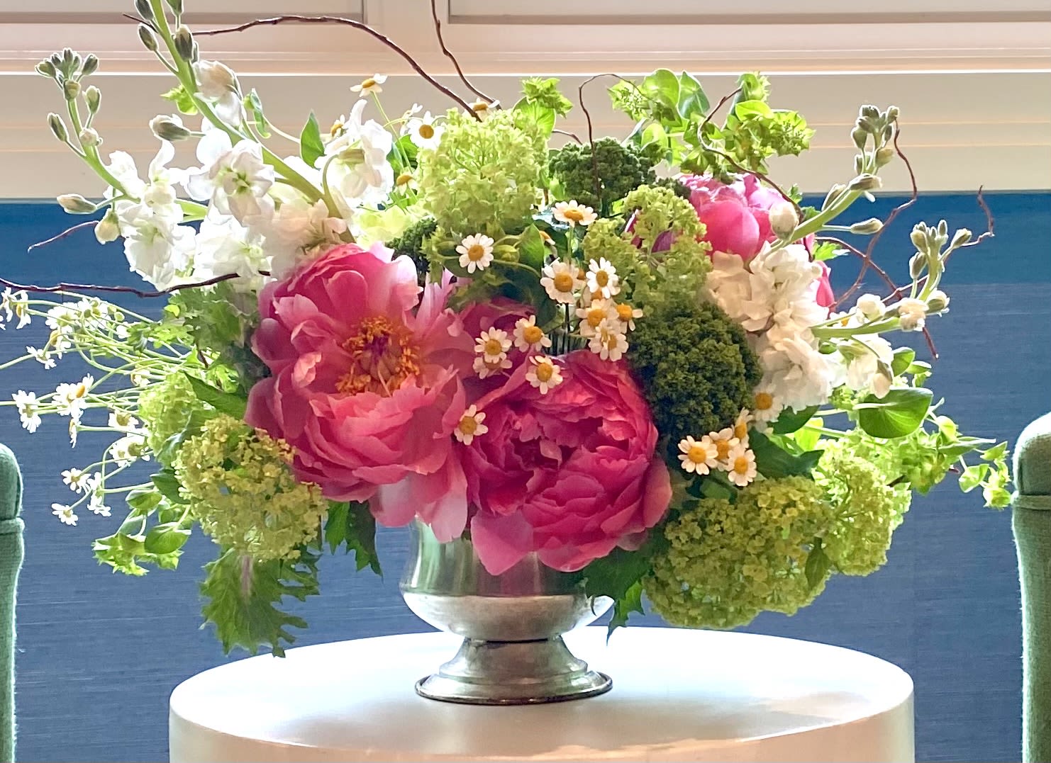 Pink and white floral arrangement in a silver vase