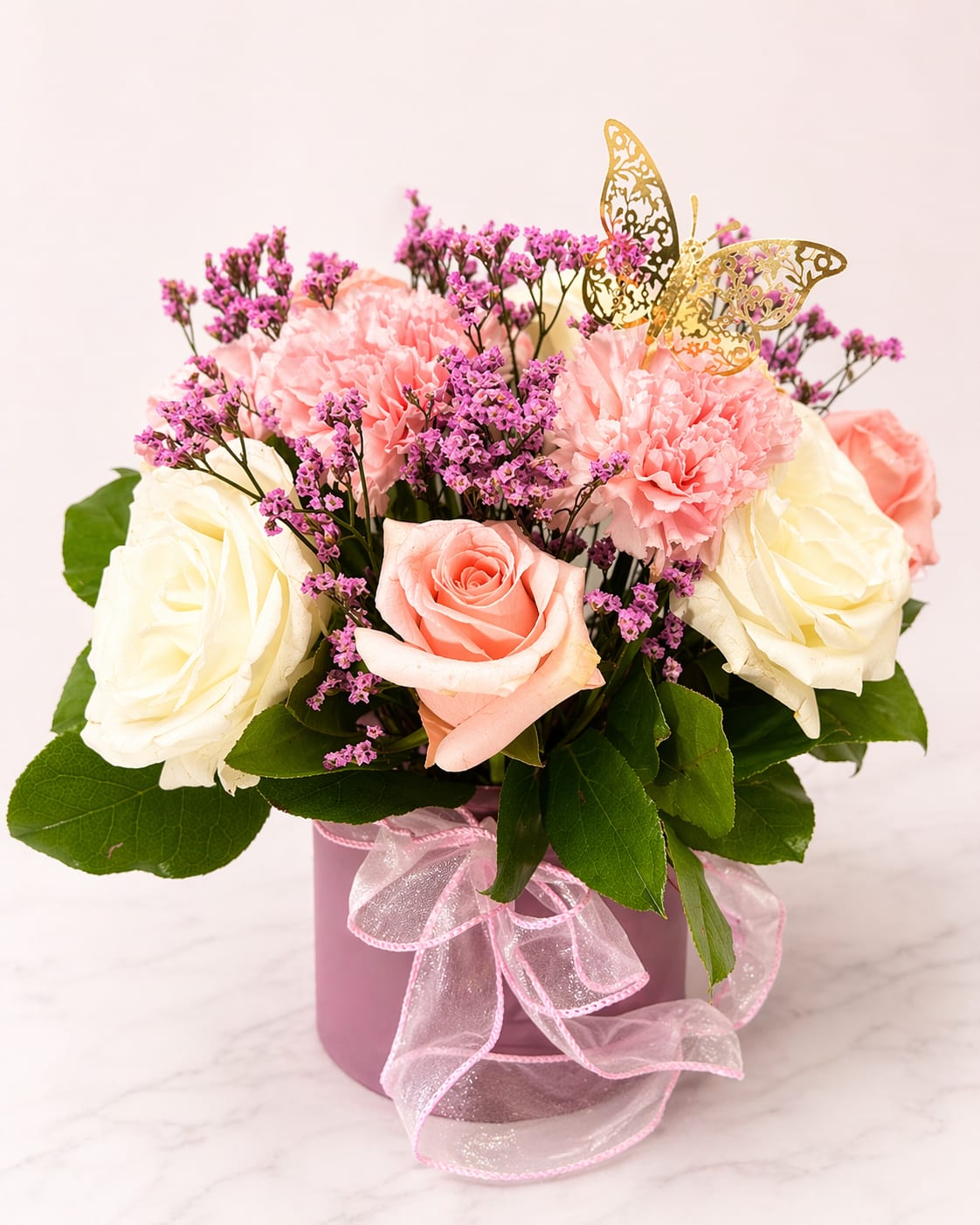 Pink Lady - Soft, sweet, and effortlessly elegant, Pink Lady is a charming arrangement designed to delight. Featuring a beautiful blend of ivory roses, blush pink blooms, and delicate accents of textured filler, this piece brings together romance and grace in the most graceful way.  Arranged in a modern blush-toned vessel and finished with a soft ribbon detail, Pink Lady is perfect for celebrating life’s special moments—from birthdays and thank-yous to “just because.”  A timeless beauty with a feminine touch—made to brighten any space and every mood.