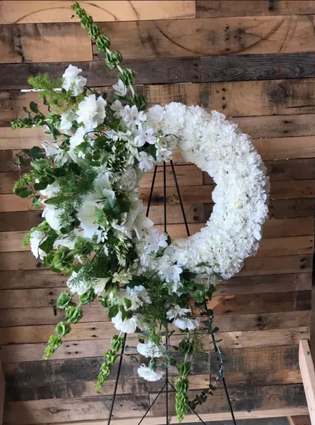 Love Pours Wreath  - Lovely Wreath design for a baby shower, wedding, or sympathy event.   Wreath includes: Carnations, Bells of Ireland, and more. 