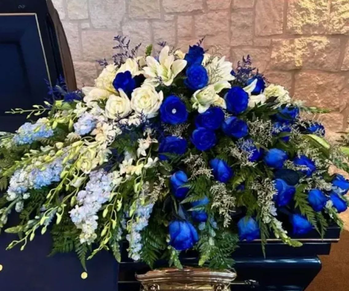 Blanket of Memories Casket Spray - Flowing across like a comforting blanket, this tribute symbolizes the many memories shared, the love that remains, and the lasting presence of a life well lived.  Blanket of Memories offers a beautiful and heartfelt way to honor and remember someone who will always be held close in the hearts of those they touched.  