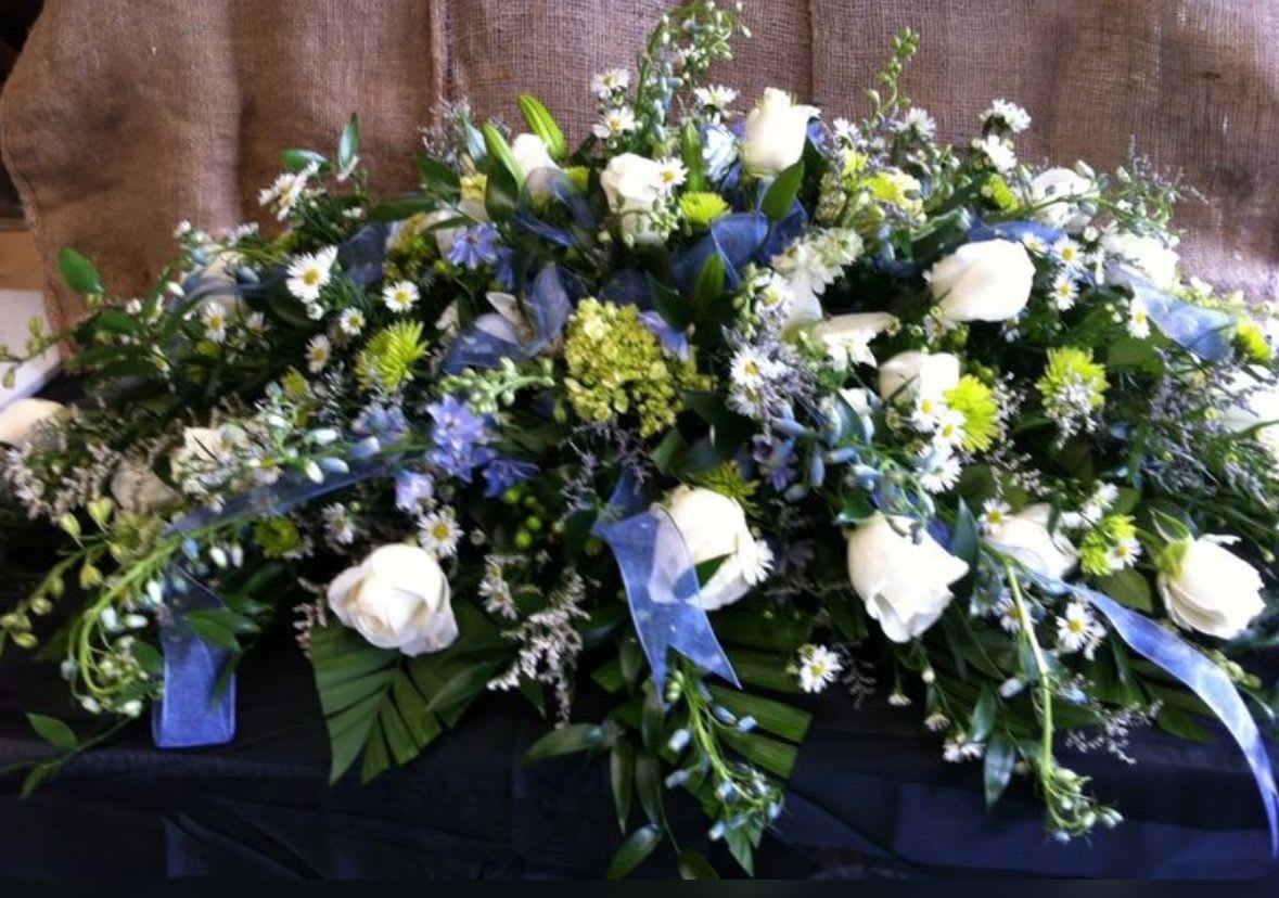 Quiet Strength Tribute Casket Spray - A dignified tribute that reflects a life of steady character and enduring love. This arrangement symbolizes resilience, loyalty, and the quiet strength that leaves a lasting legacy. 