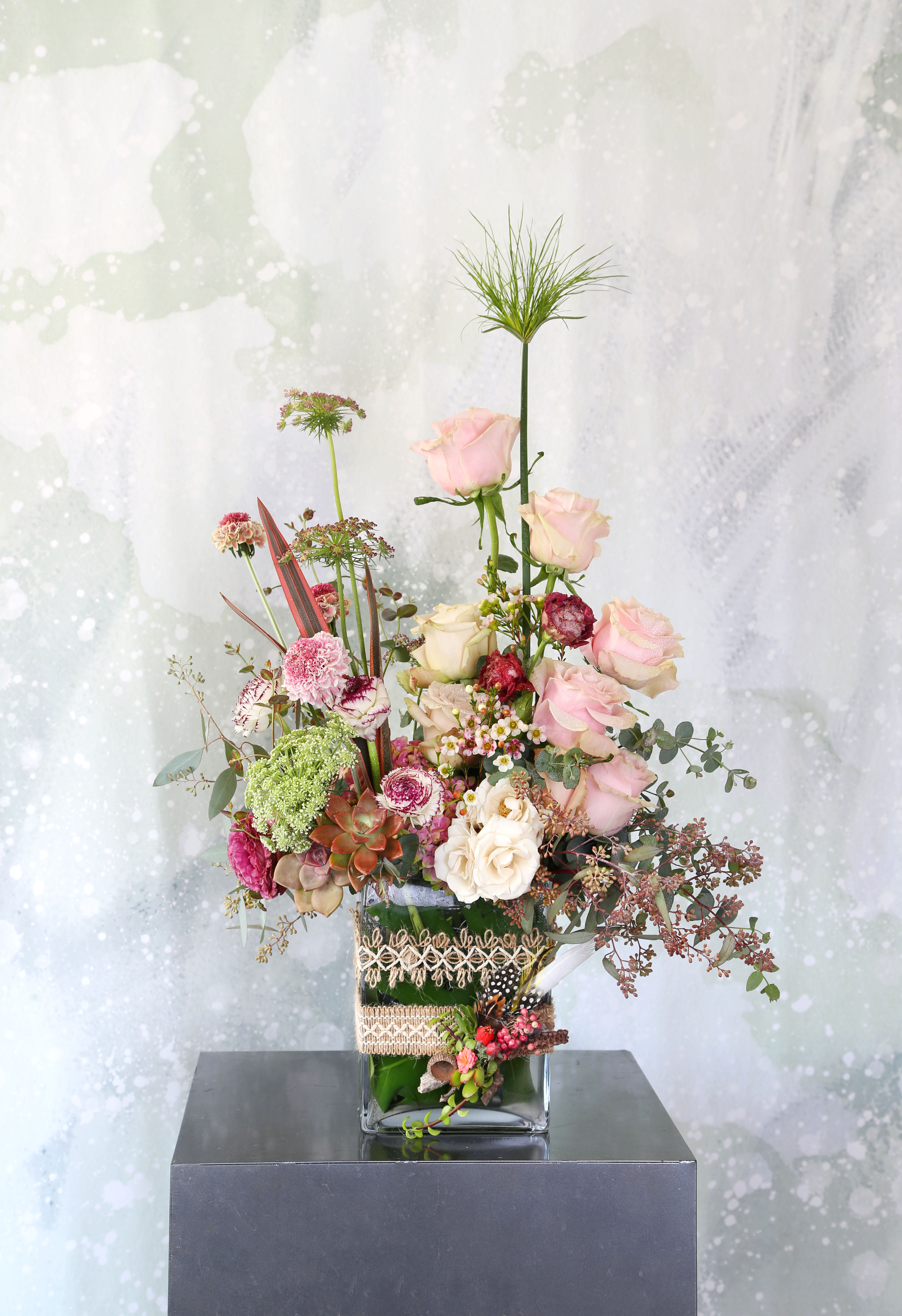 Eternal love garden - This arrangement made with a dozen different shade blush to ivory garden rose, Japanese ranunculus and Lisianthus with seasonal bloom and green. This elegant arrangement come with 8" tall rectangular vase. The vase decor with our signature hand craft woodland piece and branded gift box. Disclaimer: Photo just represent the overall style, look and feel, which may not be able to identically replicate in some instance. We will only substitute item of equal value or higher value. 