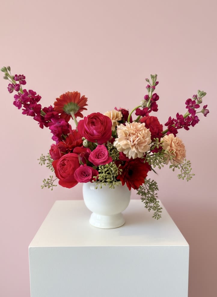Pink and red mixed bouquet in a white vase