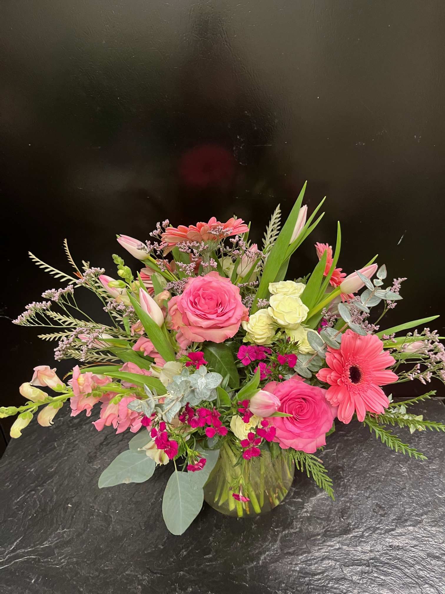 Pink and coral mixed bouquet in a glass vase