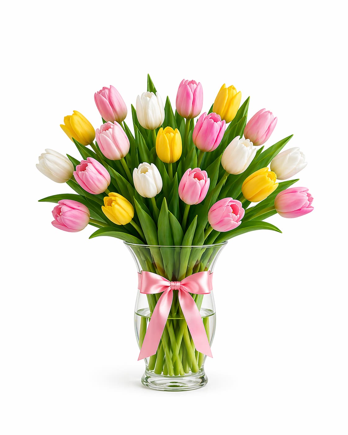 Signature Mixed Tulips in Glass Vase | 20 Tulip Arrangement - A lush and elegant floral statement, this arrangement features 18  premium tulips in a beautifully curated mix of soft pinks, whites, and yellows, thoughtfully designed in a clear glass gathering vase and finished with a delicate pink ribbon.  With a natural balance of softly opened and closed blooms, this design creates movement, texture, and a full, garden-inspired look. The visible stems and fresh water presentation add a clean, modern touch, while the ribbon detail brings a soft, feminine finish perfect for gifting.  This arrangement includes 20 tulips. Colors may vary while maintaining a soft, curated palette.  Better for: Mother’s Day, birthdays, thank you, get well, or when you want to make a more generous and memorable impression. 