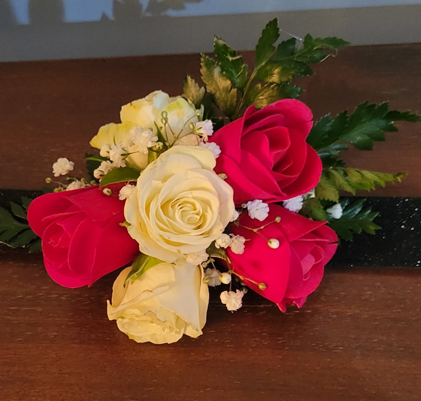 Bouquet of red and white roses with small white filler flowers