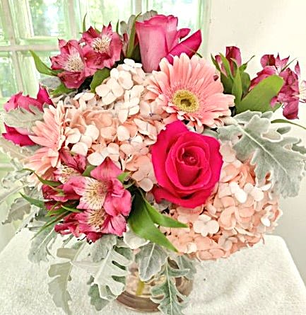 Pure Romance - Bright pink roses and magenta alstroemeria pop against pale pink hydrangea and soft pink gerbera in this romantic flower arrangement-an ideal birthday bouquet or thank-you gift with a feminine, garden-inspired feel. The contrast of vivid pink accents and silvery foliage gives the composition a fresh, airy look that reads cheerful and intimate for springtime celebrations or just because moments.