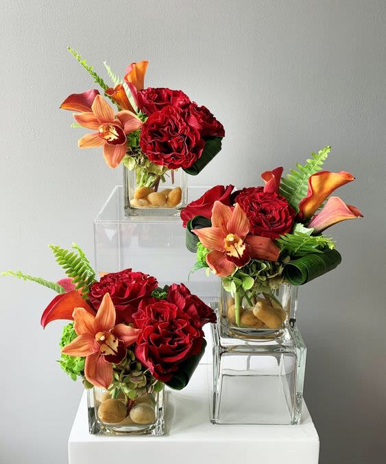 Red-y for Fall Trio Set - Embrace the spirit of autumn with our "Red-y for Fall Bouquet," a stunning set of three beautiful centerpieces. This vibrant collection showcases rich reds, warm oranges, and lush greens, adding a delightful splash of seasonal color to any setting. Ideal for cozy gatherings or festive occasions, these charming arrangements are the perfect way to celebrate fall. Brighten your home or surprise a loved one with this exquisite floral trio!