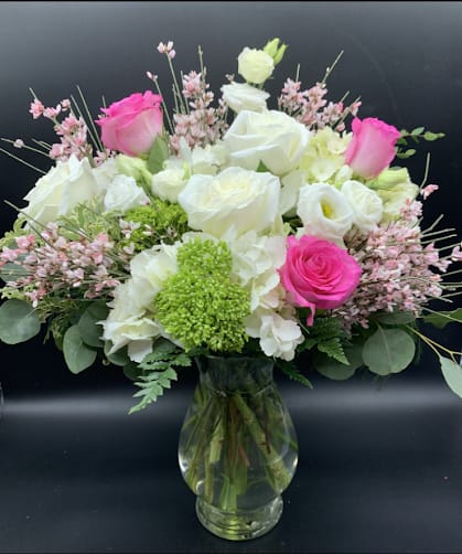 LOVE YOU ALWAYS (FEATURED DESIGN) $175/205/235 - Beautiful Mother's Day design in a tall traditional vase of pinks, green and white blooms.  This arrangement features long stem premium roses in white and pink, Lisianthus, Snap Dragons and Stock. Pictured at regular price but may be upgraded to deluxe or premium.  PS: Don't forget to add a candle and some chocolates!
