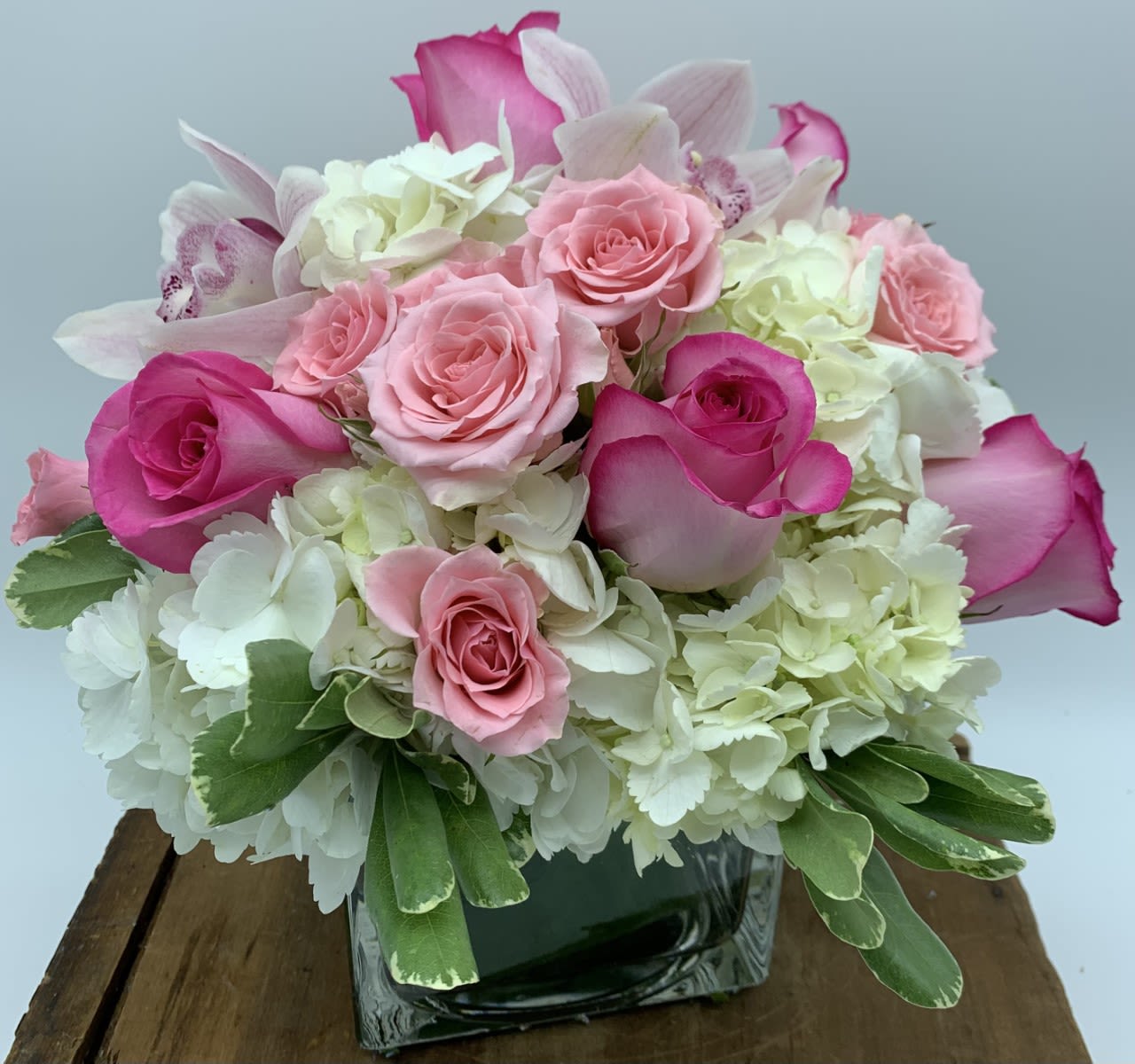 Abundantly Beautiful Vase $120/150/180 - A lush vase design of hydrangea, roses, spray roses and Cymbidium orchid.  They make a beautiful expression of love! Don't forget to add some chocolates and a candle.  Please note: It is sometimes necessary to substitute a container or flower.  We will always keep the overall coloring and aesthetic of the design.   