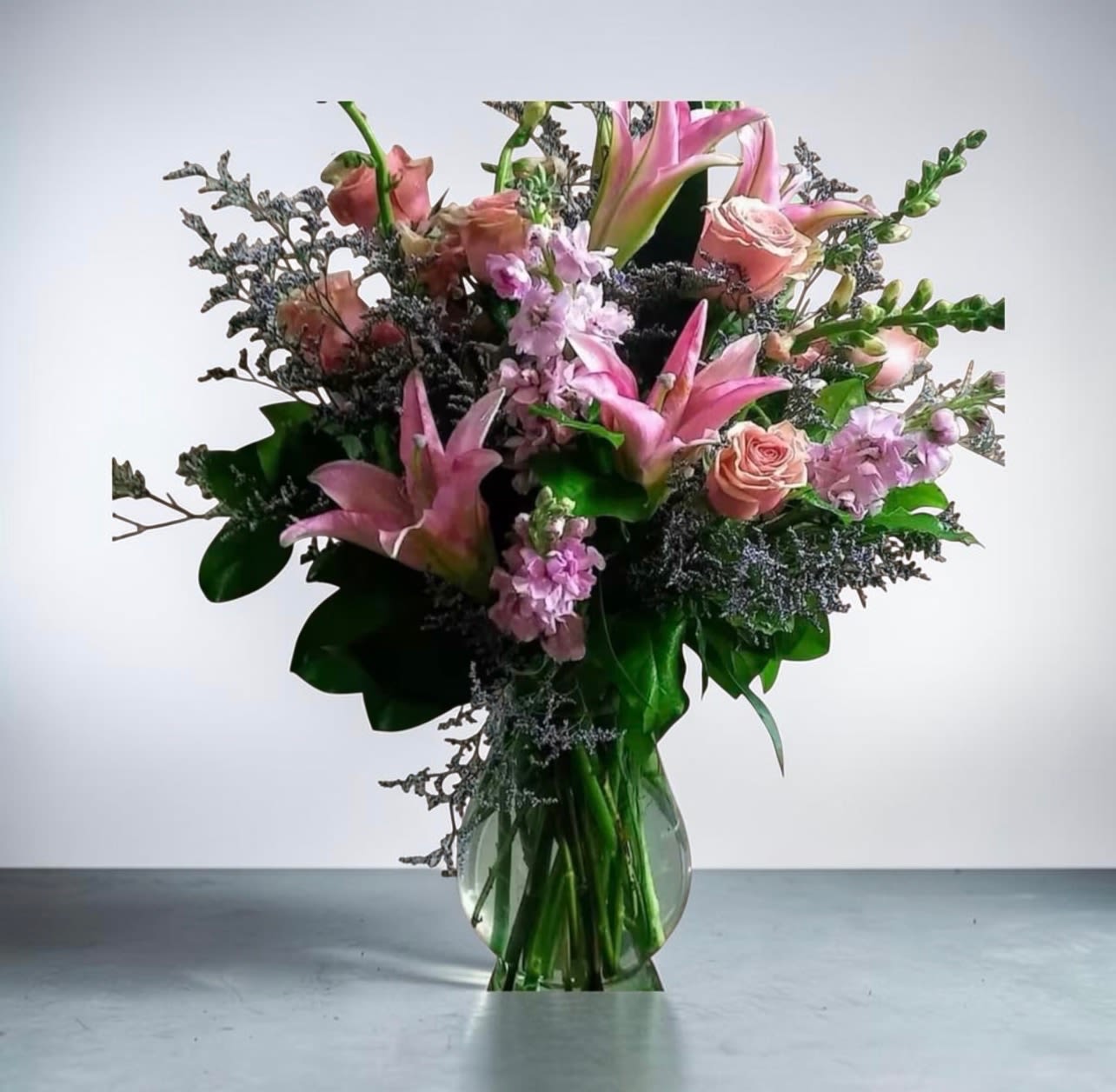 Forever Love - This arrangement is filled with 1/2 dozen of our beautiul premium roses, lilies, stock, snampdragons and more. Makes a perfect gift for any occasion!
