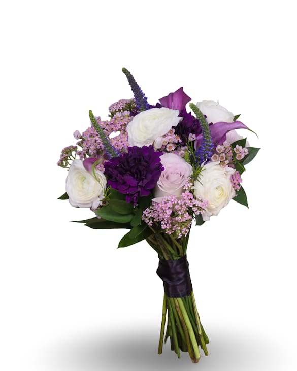 Moonlit Elegance Prom Posy - Moonlit Elegance Posy brings a softly dramatic look to weddings and special events such as prom with its rounded hand-tied design-perfect as a posy. White and blush roses set a luminous base while saturated purple blooms and pale pink calla lilies provide striking contrast, so the person you're celebrating will feel both seen and honored in the moment.  This bouquet layers textures for visual depth: full roses and calla lilies are surrounded by clustered dianthus and airy filler flowers that soften the stronger purple accents. Stems are finished with a dark satin ribbon wrap for a polished, formal presentation that reads beautifully against light or deep gowns.  Moonlit Elegance is sized to be comfortably hand-held and designed to photograph well under evening light. For best freshness, keep stems in water until the event and store in a cool place; orders come hand-tied and ready to carry.