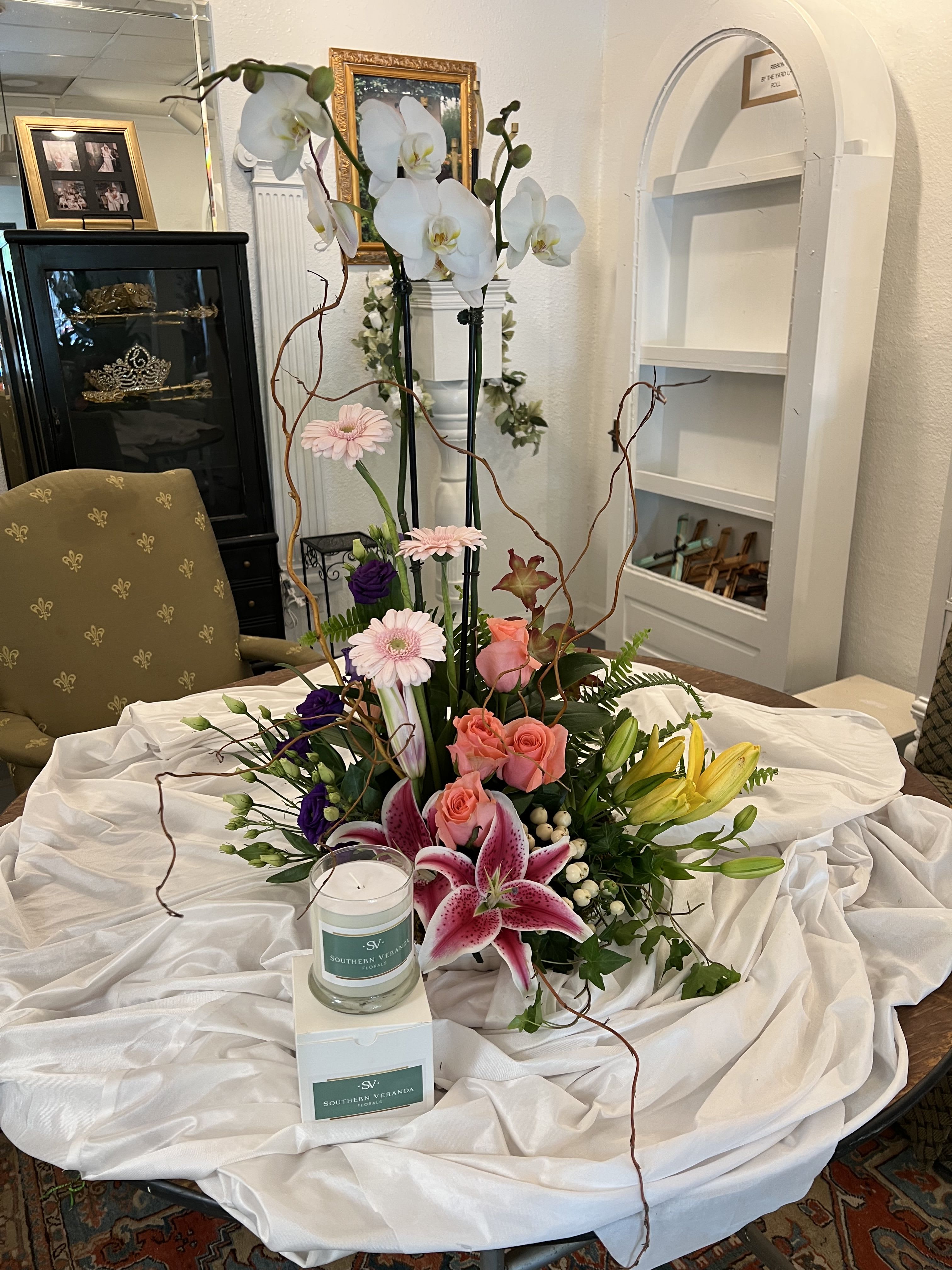 Mother's Day Blooms Gift Set - Mom will be delighted to recieve these fresh cut spring florals centered around a beautiful orchid plant and an SV signature scent candle! Arrangment will be in same color scheme and style but specific flowers used will be based on availability.