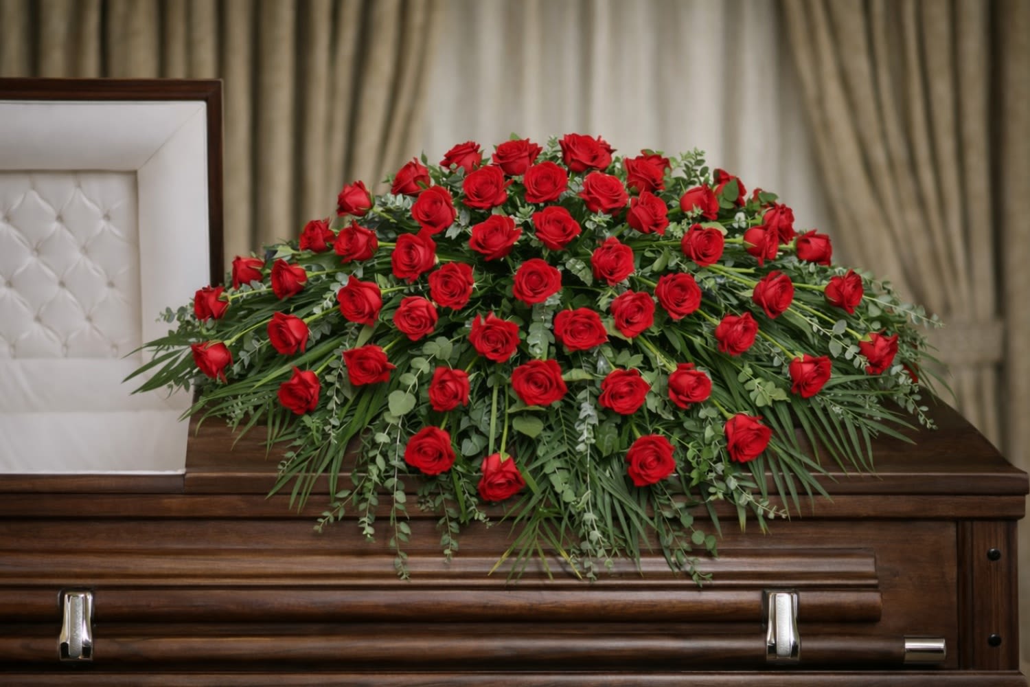 Majestic Casket Spray  - The Majestic Casket Spray from FloralFabulous is a bold and deeply meaningful tribute designed to express love, honor, and enduring remembrance. This stunning arrangement features a full display of rich red roses, beautifully arranged with flowing greenery to create a lush and elegant presentation.  Red roses symbolize deep love, respect, and devotion, making this arrangement an especially powerful choice for honoring a spouse, partner, or deeply cherished loved one. Designed to rest gracefully atop the casket, the Majestic Casket Spray creates a striking and emotional focal point during funeral and memorial services.  Its full, luxurious design offers a timeless expression of sympathy while celebrating a life filled with love and meaningful memories. The cascading greenery adds softness and movement, enhancing the natural beauty of the roses.  FloralFabulous proudly provides funeral flower delivery and casket sprays in Round Rock, TX and the greater Austin area, helping families express heartfelt condolences with elegance, care, and compassion.
