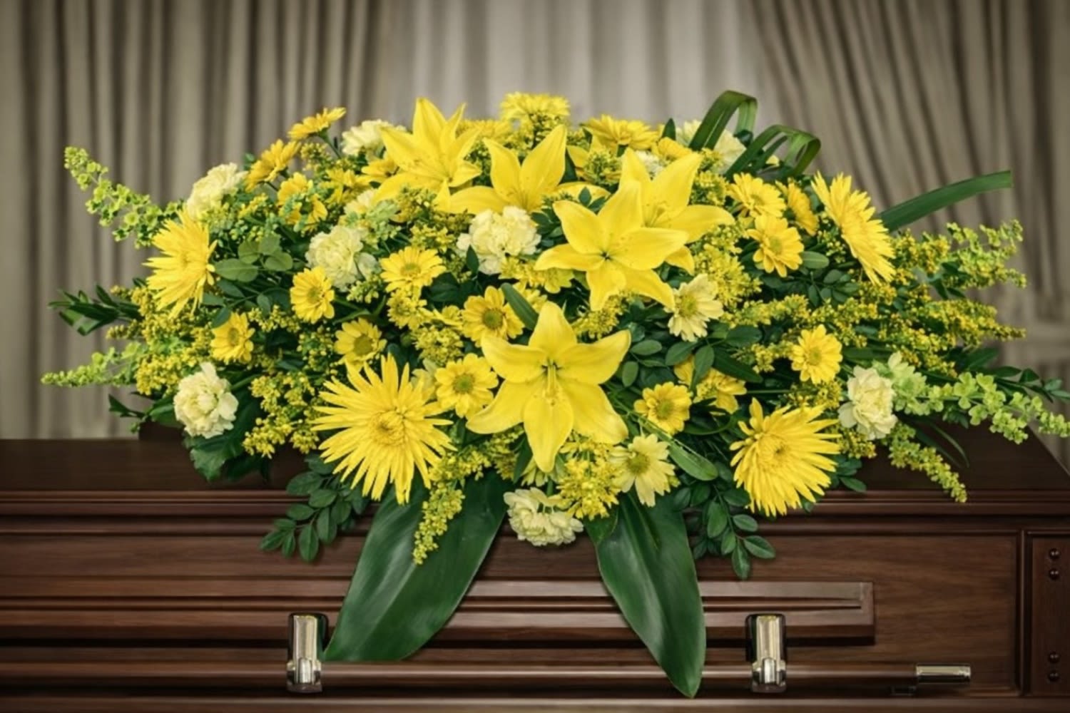 Sunshine Casket Spray Arrangement - The Sunshine Casket Spray from FloralFabulous is a radiant and heartfelt tribute designed to honor and celebrate a life filled with warmth, love, and cherished memories. This beautiful casket arrangement features vibrant yellow lilies, cheerful spider chrysanthemums, daisy chrysanthemums, soft carnations, and delicate solidago, all artfully arranged with lush greenery.  The bright yellow color palette symbolizes friendship, remembrance, and the celebration of a life well lived. Designed to rest gracefully atop the casket, this arrangement creates a meaningful focal point during funeral and memorial services, offering comfort, warmth, and encouragement to family and friends.  The Sunshine Casket Spray is an ideal choice for families who wish to honor their loved one with flowers that reflect positivity, light, and a joyful spirit. Its full, flowing design provides a respectful and elegant expression of sympathy while celebrating a beautiful life.  FloralFabulous proudly offers sympathy flower delivery and funeral arrangements in Round Rock, TX and the greater Austin area, helping families express love, remembrance, and heartfelt support during life’s most difficult moments.