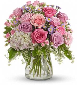 Pink and lavender rose bouquet in a clear glass vase