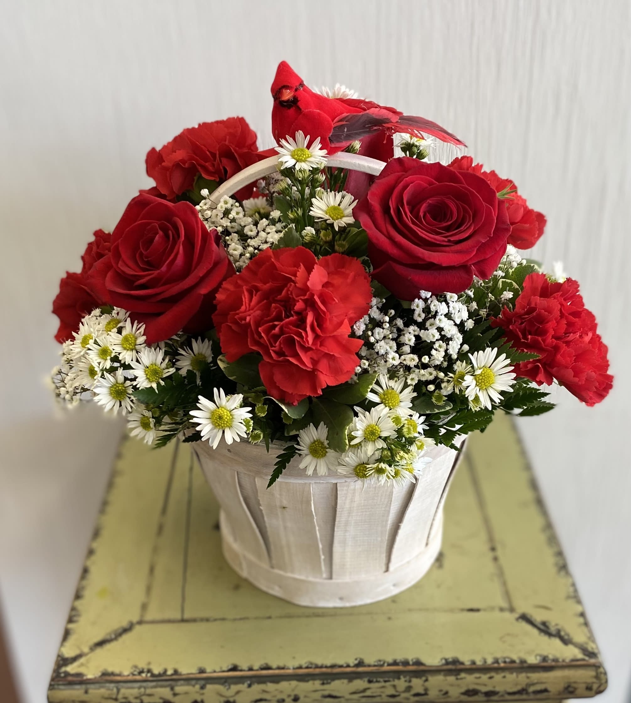 Basket of red roses and carnations with white daisy flowers