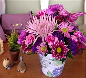 Pink and purple mixed bouquet in a floral ceramic vase
