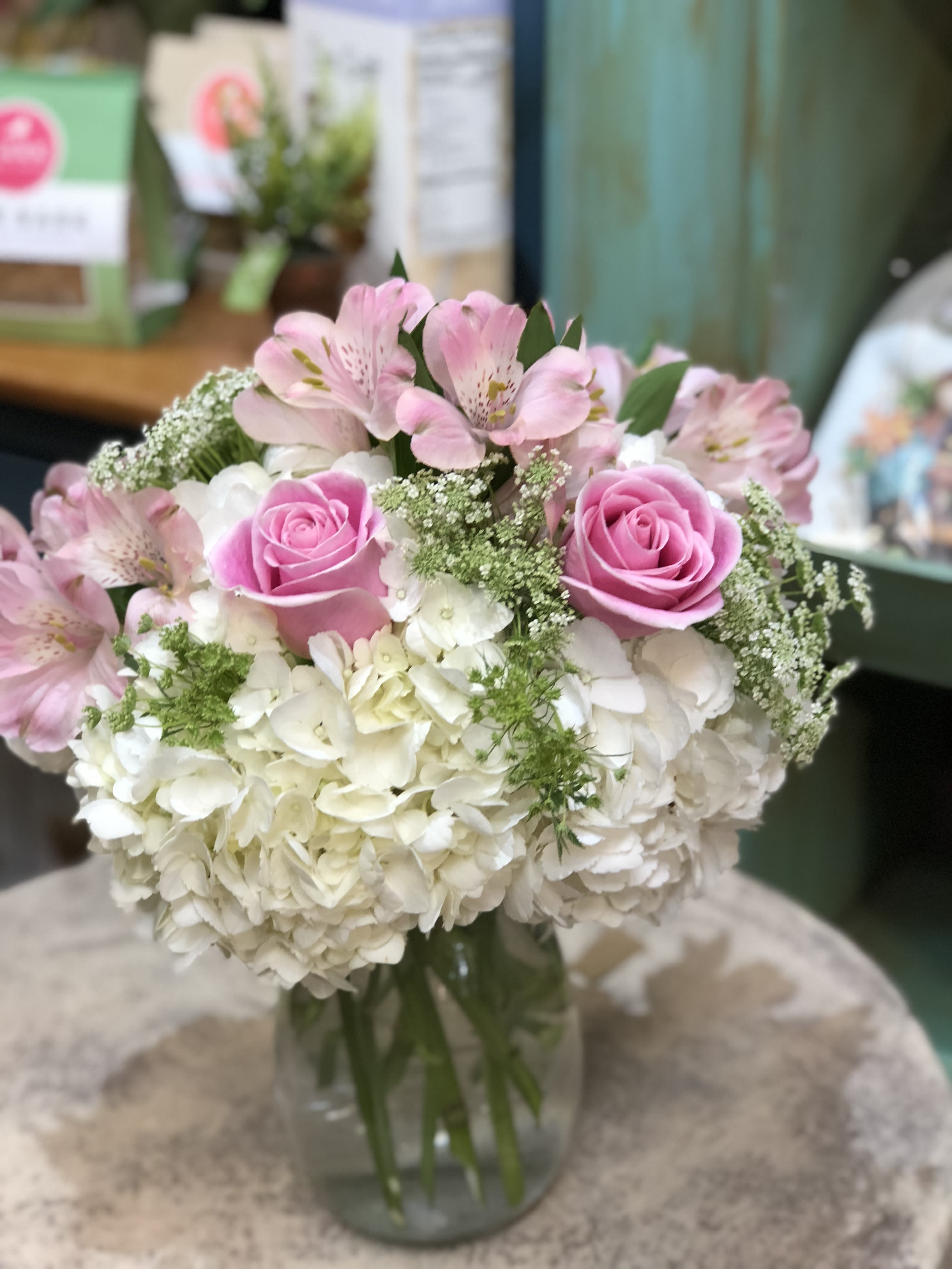 Pink roses and white hydrangeas in a glass vase