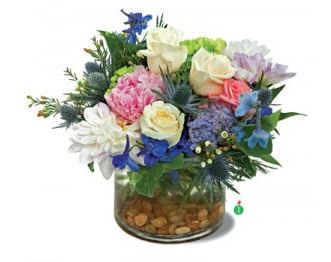 Mixed bouquet of roses, daisies, and blue flowers in a glass vase