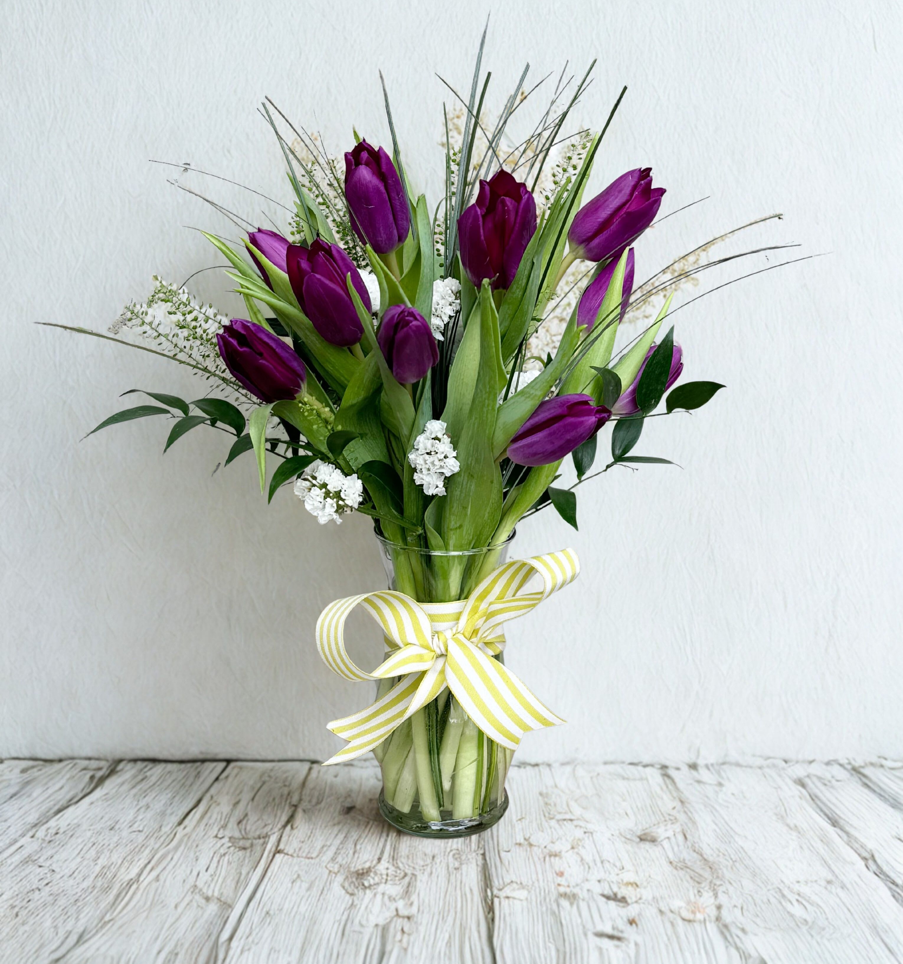 Timeless Tulips - Elegant tulips gathered in a clear glass vase create a striking vertical profile that draws the eye upward-perfect as a birthday bouquet, springtime surprise, or a thoughtful "just because" gift for someone you care about. Color of Tulips will vary.
