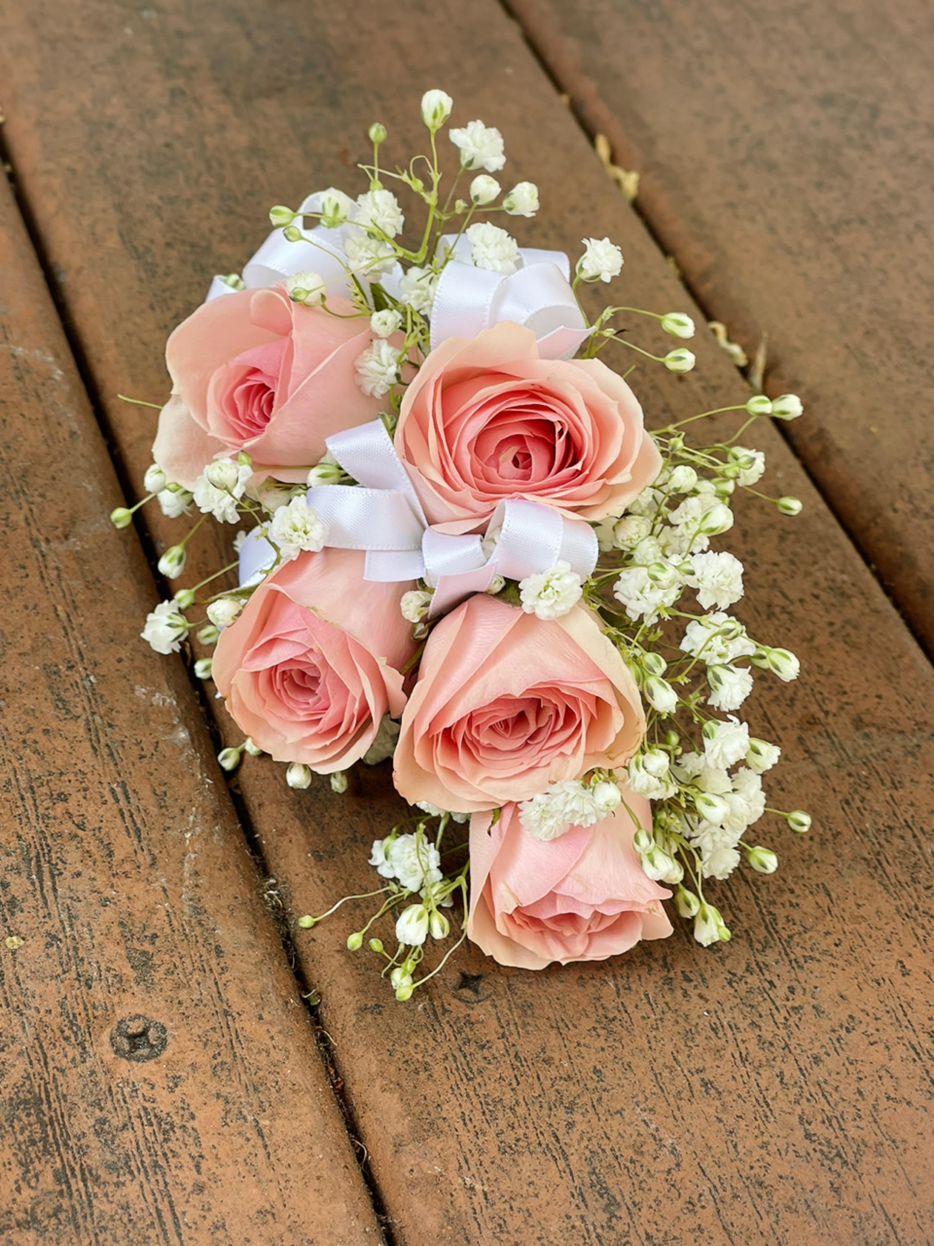 Small bouquet of pink roses with white baby's breath and ribbon