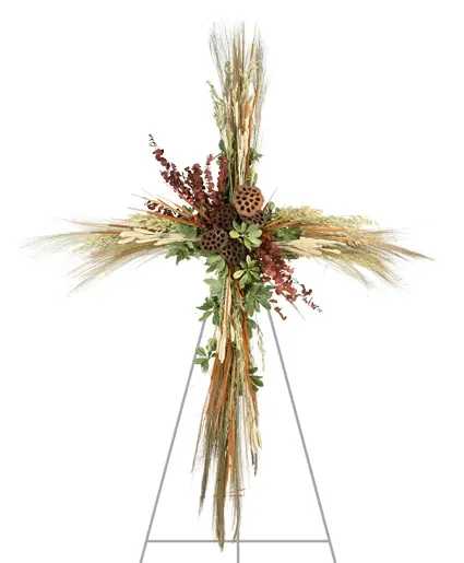 Fields of Comfort Standing Spray - Fields of Comfort is a testament to nature's enduring beauty. Crafted with dried grasses and slender cat tails, this cross standing spray offers a rustic charm that offers comfort during life’s difficult moments. Order this arrangement to provide a silent ode to cherished memories and the enduring comfort found in the embrace of nature's bounty.  Includes: Mache, Bunch Dried Grass, Bunch Dried Oat Grass, Dried Lotus Pods, Bunch Dried What, Bunch Dried Eucalyptus , Bunch Cat Tails, Variegated Pittosporum.