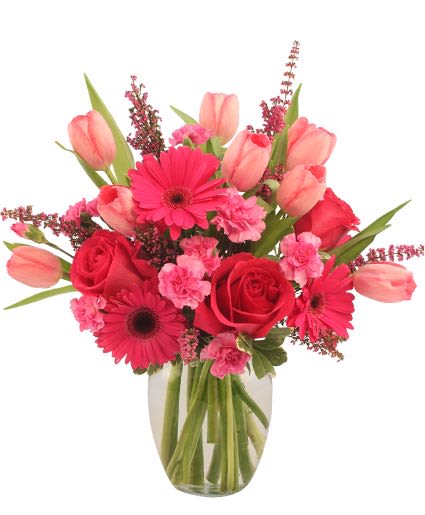 Sweet Pink Mystique Arrangement - Charming and sophisticated, this sweet bouquet is a perfect choice! Featuring a stunning mix of hot pink roses, gerberas, pink tulips, mini carnations, and more, Sweet Pink Mystique is a magnificent mix bursting with color. Share the love and send some magic today with this vibrant bouquet!  Includes: Ginger Vase, Foliage: Variegated Pittosporum, Hot Pink Roses, Pink Tulips, Hot Pink Gerberas, Pink Miniature Carnations, Fuchsia Heather.