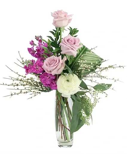 Sweet Cream &amp; Lilac Floral Design - They’ll love this sweet arrangement! Featuring stunning lavender roses, white ranunculus, purple stock, and more, Sweet Cream &amp; Lilac is a delightfully delicate mix. Send this tasteful arrangement to someone who needs a sweet treat today!  Includes: Bud Vase, Calathea Leaves, Seeded Eucalyptus, Genestra, Myrtle, Sword Fern, White Ranunculus , Lavender Roses, Purple Stock .