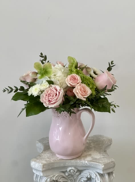 Blush Garden by Westford Florist Art by Veny - Elevate your space with the exquisite Blush Garden arrangement by Westford Florist Art by Veny. This stunning display features a harmonious blend of delicate blush pink and pristine white flowers, artfully arranged in a charming ceramic water pitcher. Perfect for any room or event, this breathtaking centerpiece brings the serene beauty of a blooming garden into your home, creating an atmosphere of elegance and tranquility. Each flower is meticulously chosen and thoughtfully arranged to ensure maximum impact, making the Blush Garden not just a decoration but a statement piece that captures nature's artistry. Transform your environment with this captivating floral arrangement today. The Blush Garden flower arrangement by Westford Florist Art by Veny is more than just an ordinary display of flowers - it is truly something special. With its delicately arranged blooms in soft shades of pink and white displayed in an elegant ceramic pitcher, it brings both beauty and meaning into your home. Elevate your space and bring a touch of nature indoors with this exquisite arrangement from Westford Florist Art by Veny.
