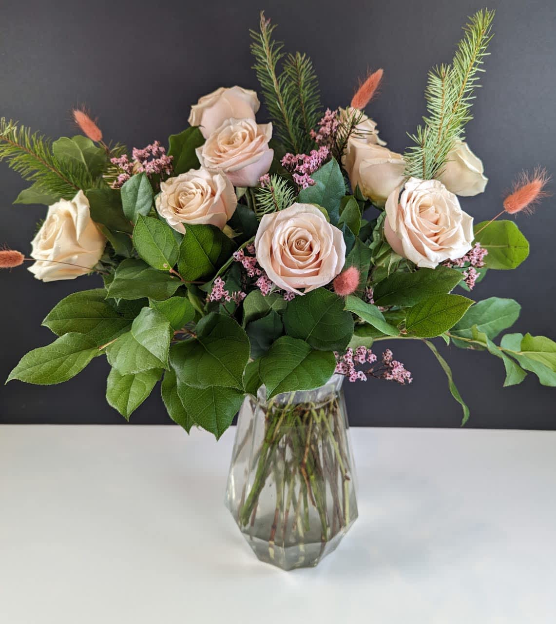 Bouquet of pale blush roses in a clear glass vase