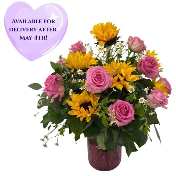 Pink Charms - Select this beautiful and bright arrangement featuring pink roses, sun flowers, and chamomile.  Filler flower may vary