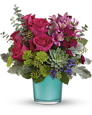 Topaz Wonderland - This wondrous arrangement features dark pink roses, dark pink alstroemeria, miniature purple carnations, green button spray chrysanthemums, blue sinuata statice, dusty miller, spiral eucalyptus, seeded eucalyptus, lemon leaf, and a large green echeveria succulent plant.