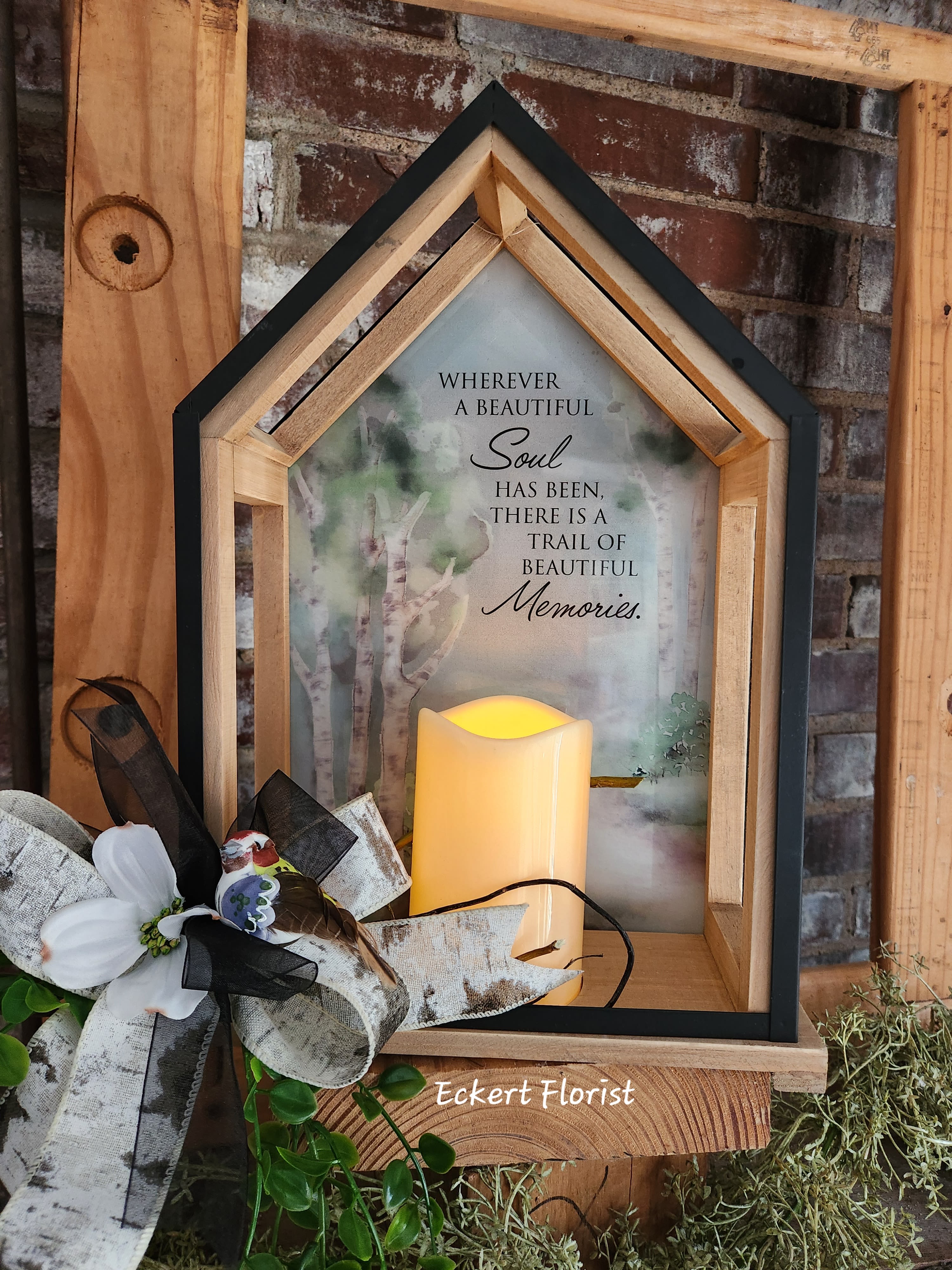 Wooden memorial lantern with a candle and floral bow