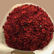 Round bouquet of tightly packed red roses