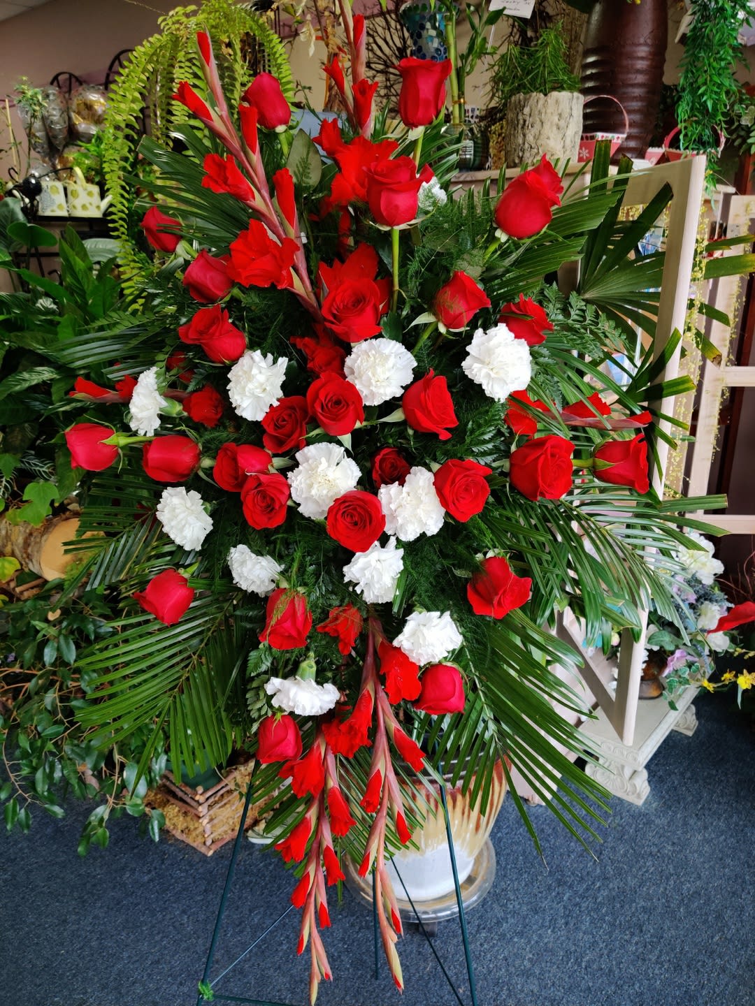 Large standing floral spray with red roses and white carnations