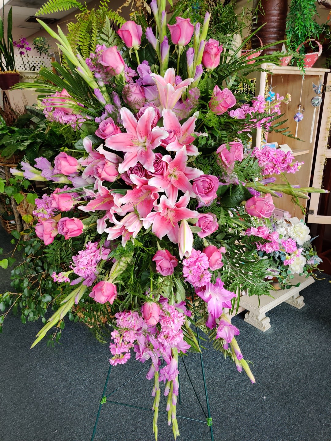 Large pink floral standing spray with lilies and roses