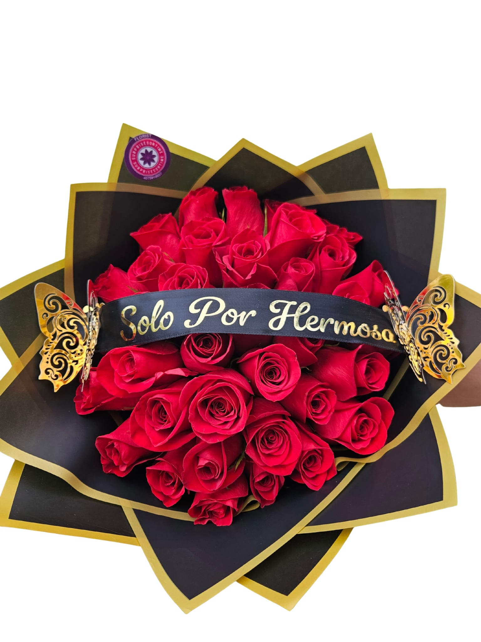 Bouquet of red roses wrapped in black and gold paper with a ribbon