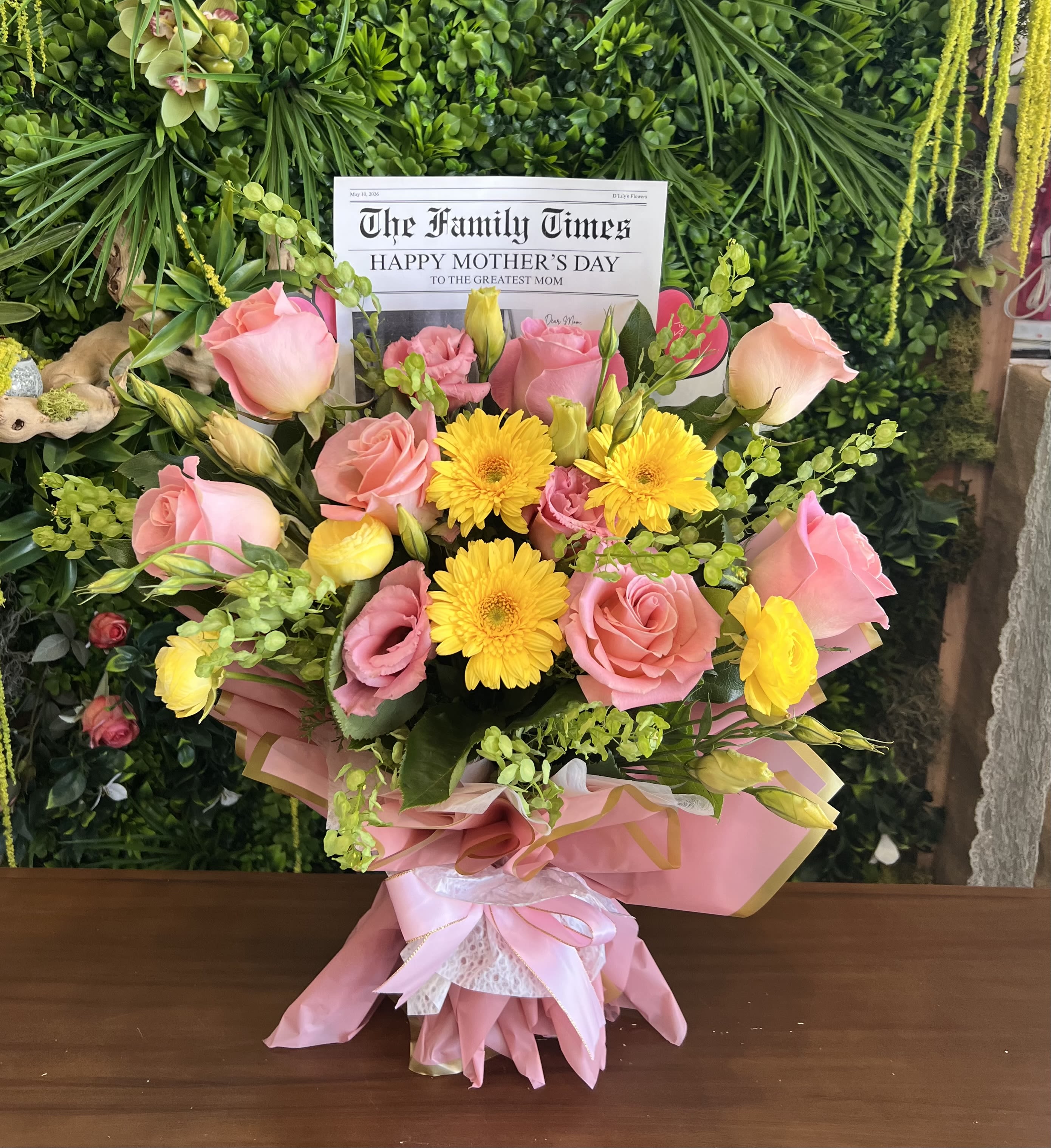 Mothers Day Sunshine  - A cheerful mix of blush pink roses and sunny yellow blooms, beautifully wrapped in soft pastels—perfect for celebrating Mom with love and warmth.