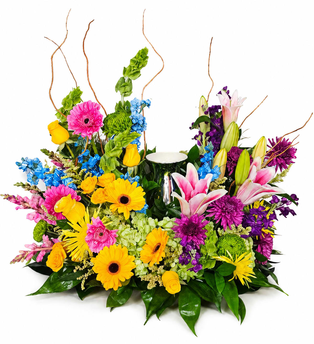 Bright Heavenly Garden Urn Arrangement - Honor a beautiful life with this vibrant urn arrangement, thoughtfully designed to surround a cherished keepsake with warmth and color. Featuring a lively mix of yellow gerbera daisies, pink lilies, roses, purple mums, and seasonal accents, this piece brings together bold hues and soft textures to create a meaningful tribute. Accented with lush greenery and natural elements, the design offers a balanced, elegant presentation that celebrates life, love, and lasting memories.  Perfect for memorial services, celebrations of life, or home remembrance, this arrangement provides a comforting and uplifting display for family and friends.  Urn is not included.