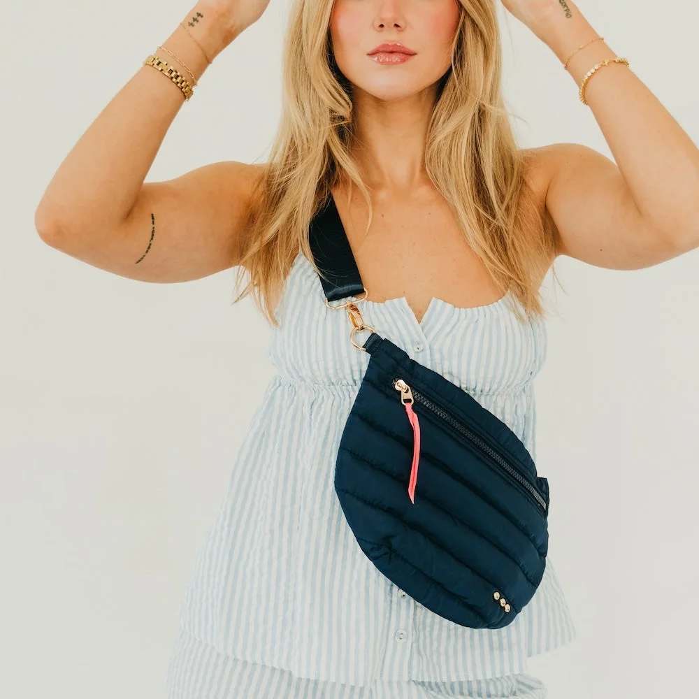 Jolie Puffer Bum Bag Navy - * Adjustable waist / shoulder strap up to 45 inches. Starts at 27 inches. * Exterior zipper pocket for easy access to your credit cards and ID and phone Black and white striped lining. * Bag measures 12" x 8" at the longest points. * Main material: Quilted Puffer Polyester; Other: Sponge and poly/cotton liner * Spot Clean 